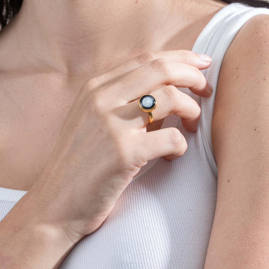 Woman wearing gold plated moon phase ring