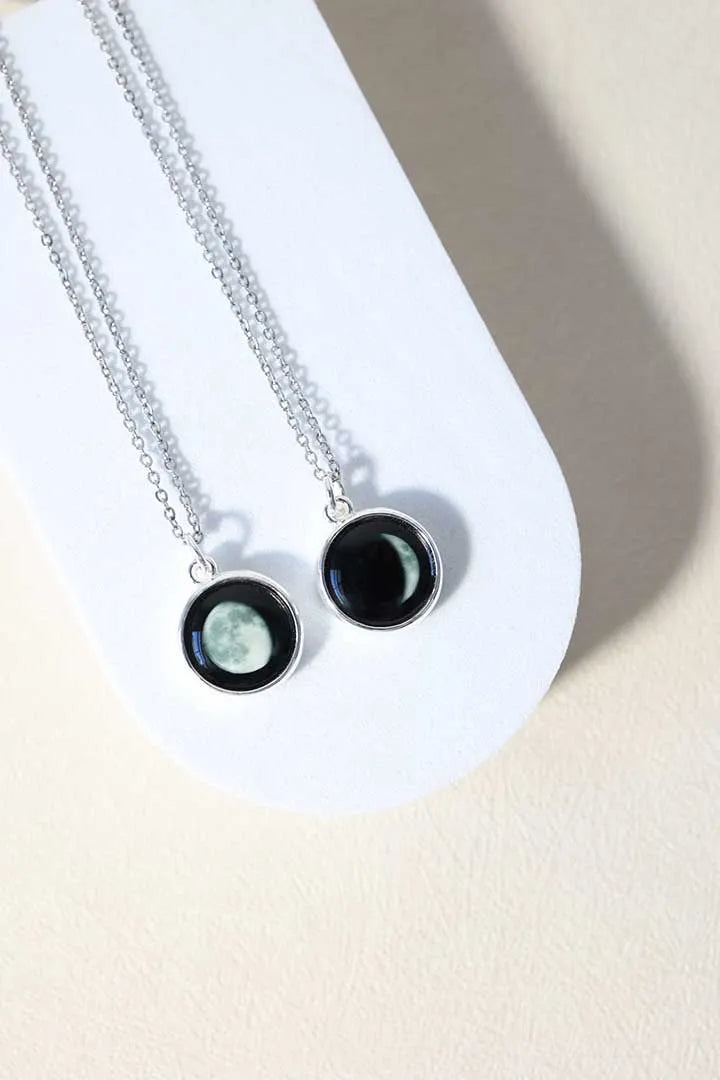 Model wearing a circular Moonglow moon-phase pendant