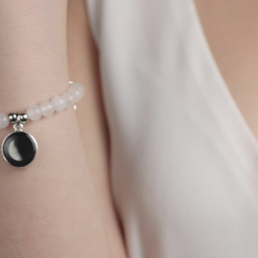 Video of woman wearing beaded bracelet with silver plated moon charm