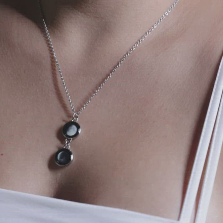 Video of woman wearing silver plated 2 moon pendant necklace