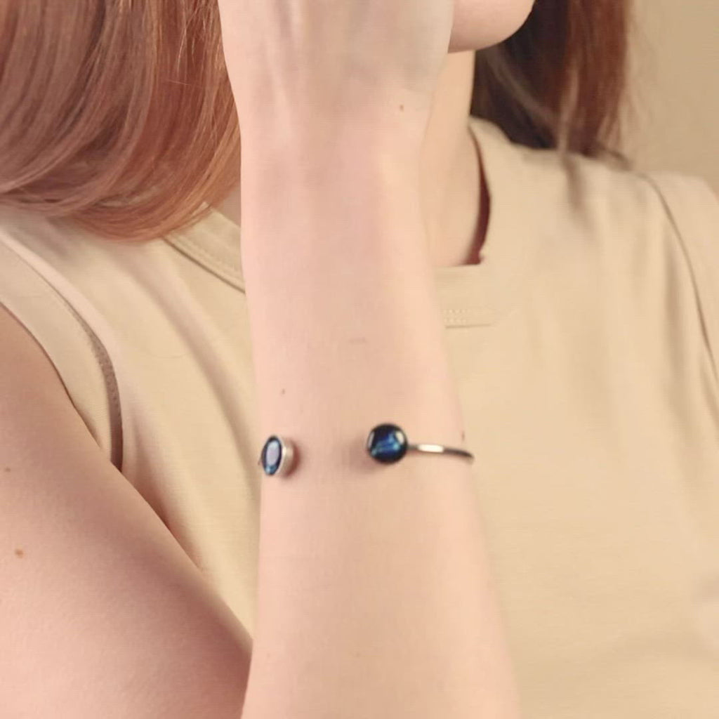 Video of woman wearing double astral constellation cuff bracelet