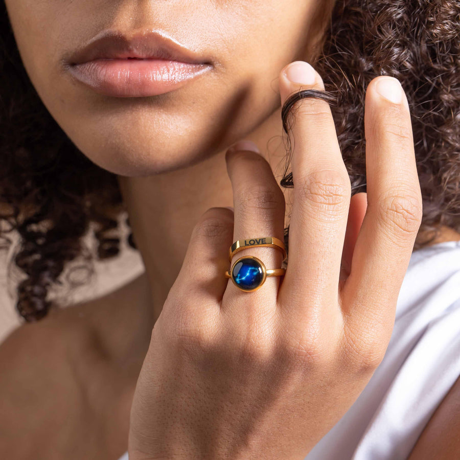 Woman wearing gold plated constellation astrology ring and gold plated engravable ring 