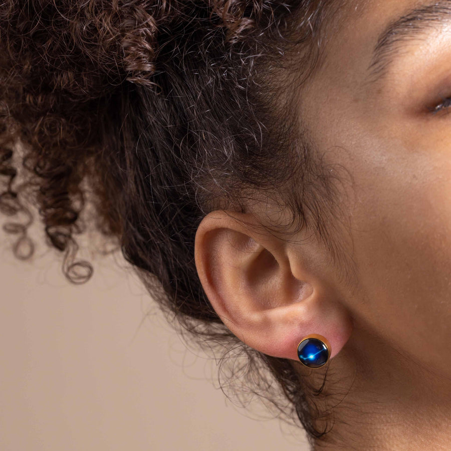 woman wearing gold plated constellation astrology and moon phase stud earrings