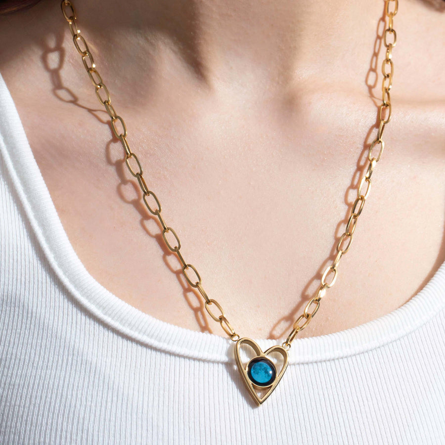 woman wearing a Moon phase Atlas Heart Necklace in Gold