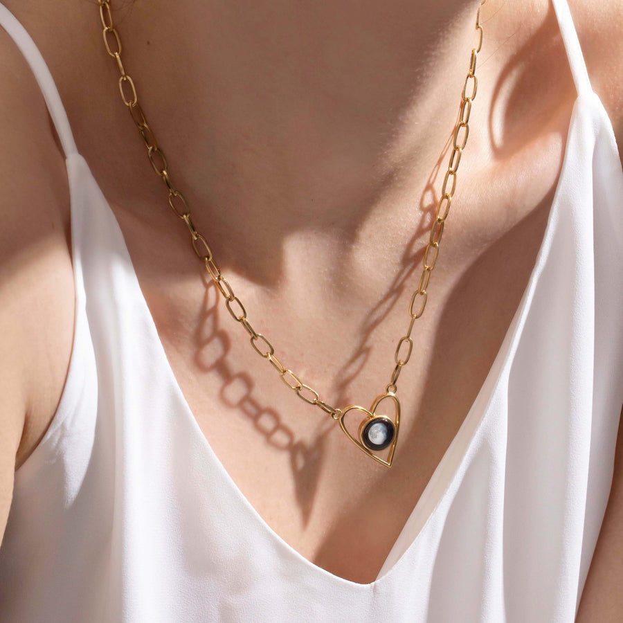 Woman wearing Moon phase Atlas Heart Necklace in Gold