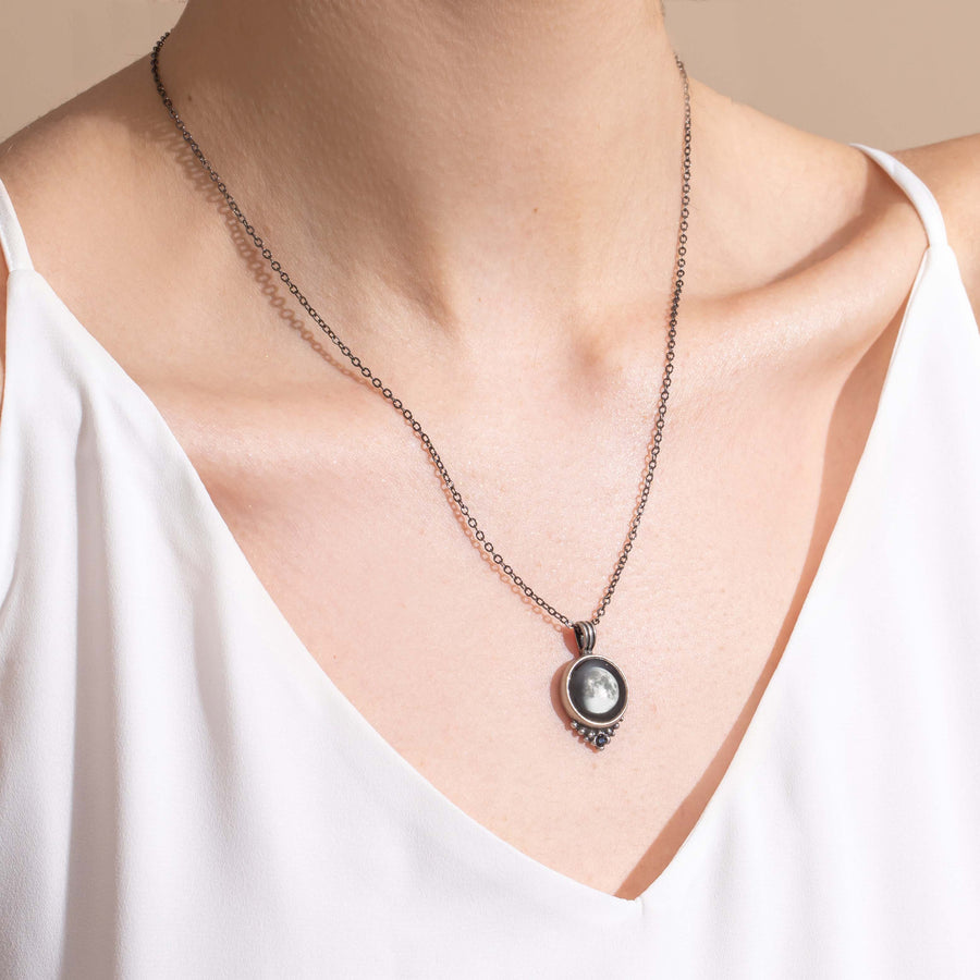 Woman wearing pewter moon phase necklace