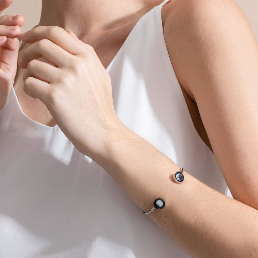 Woman wearing 2 moon phase cuff bracelet in stainless steel