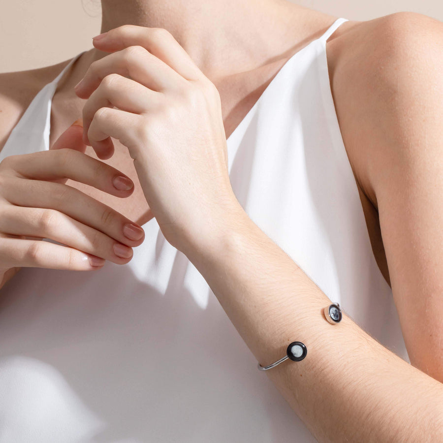 Woman wearing 2 moon phase cuff bracelet in stainless steel