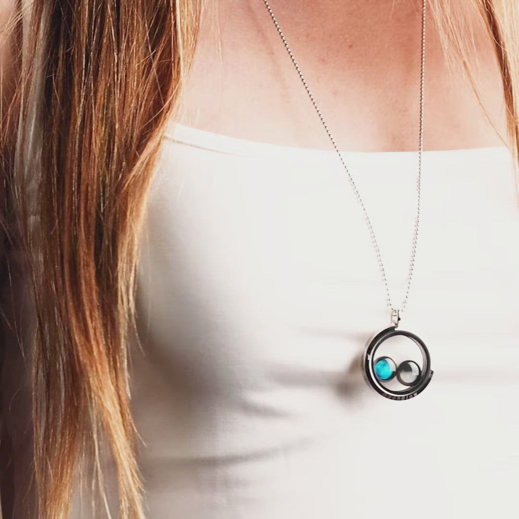 Video of woman wearing two moon phase locket necklace in stainless steel