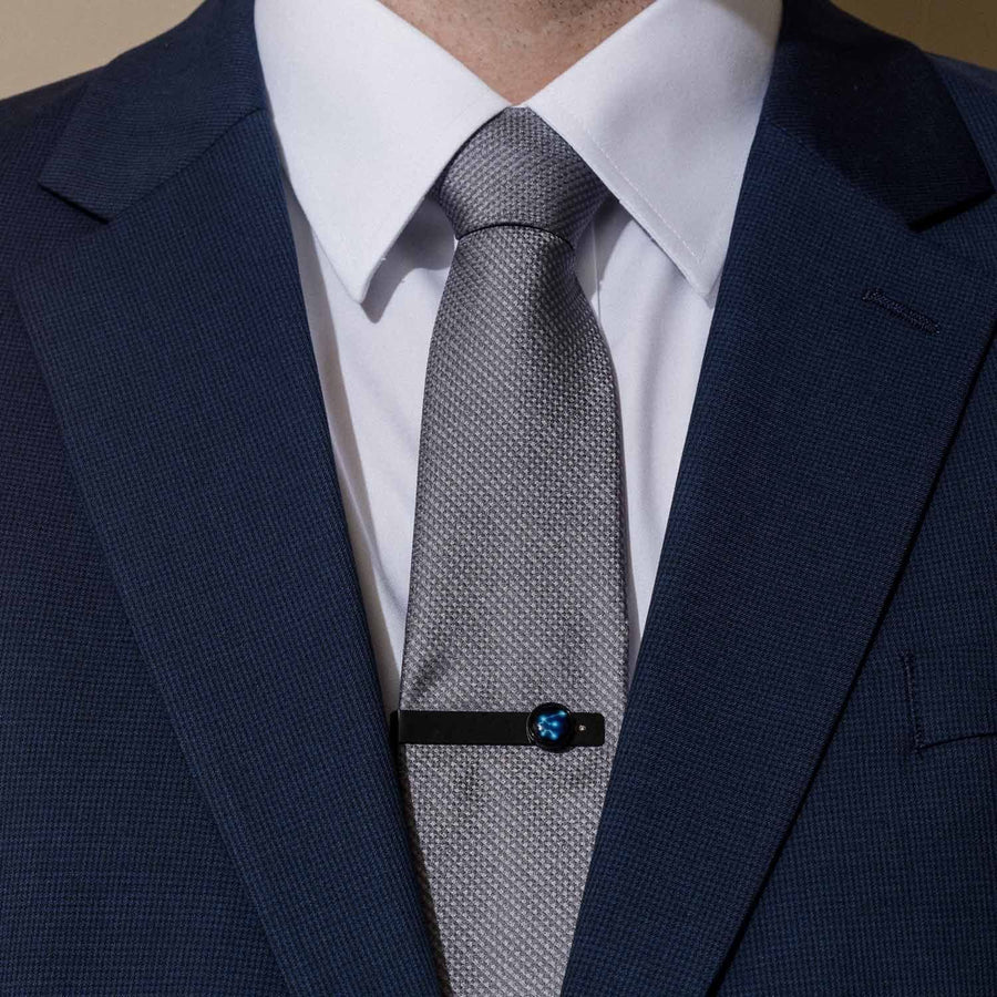 Man in a suit wearing a Constellation Astrology Tie Bar In Matte Black