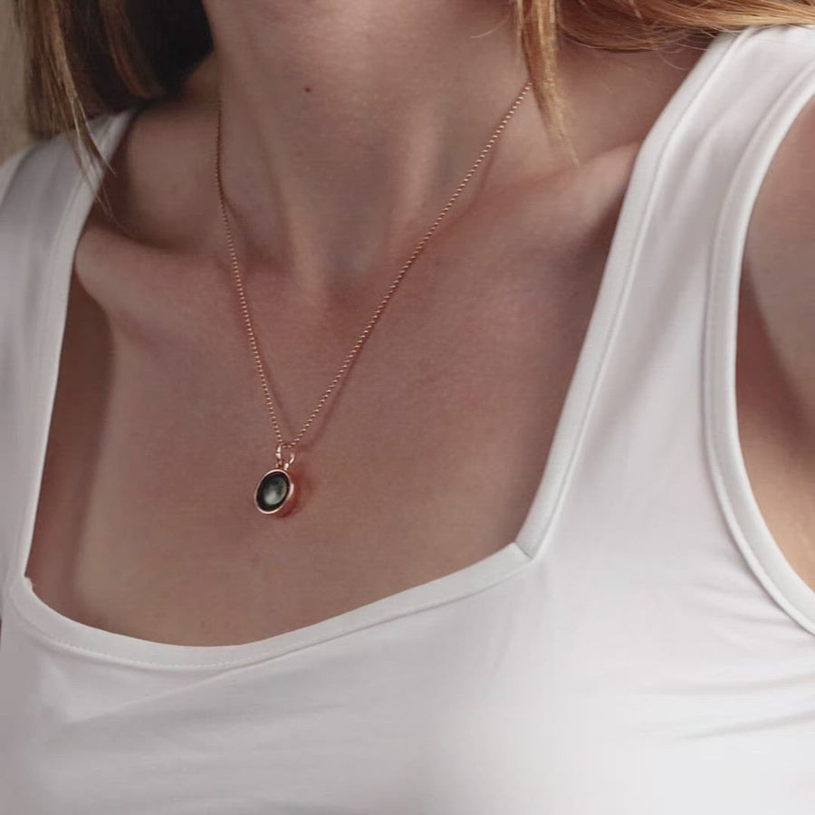 Video of woman wearing rose gold moon phase pendant necklace with beaded chain