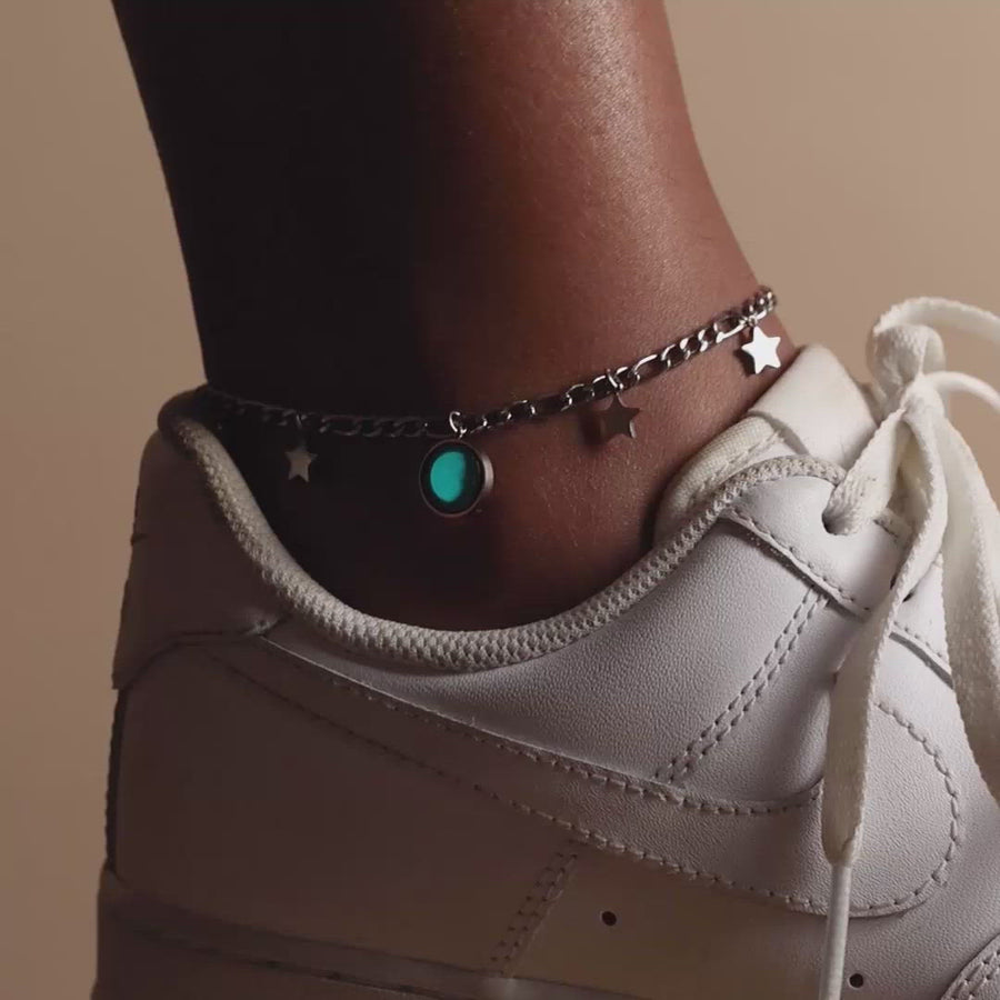 Video of woman wearing The Lunar Mae Anklet in Gold in the dark. Glow in the dark,