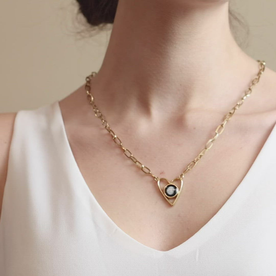 Video of woman wearing Moon phase Atlas Heart Necklace in Gold