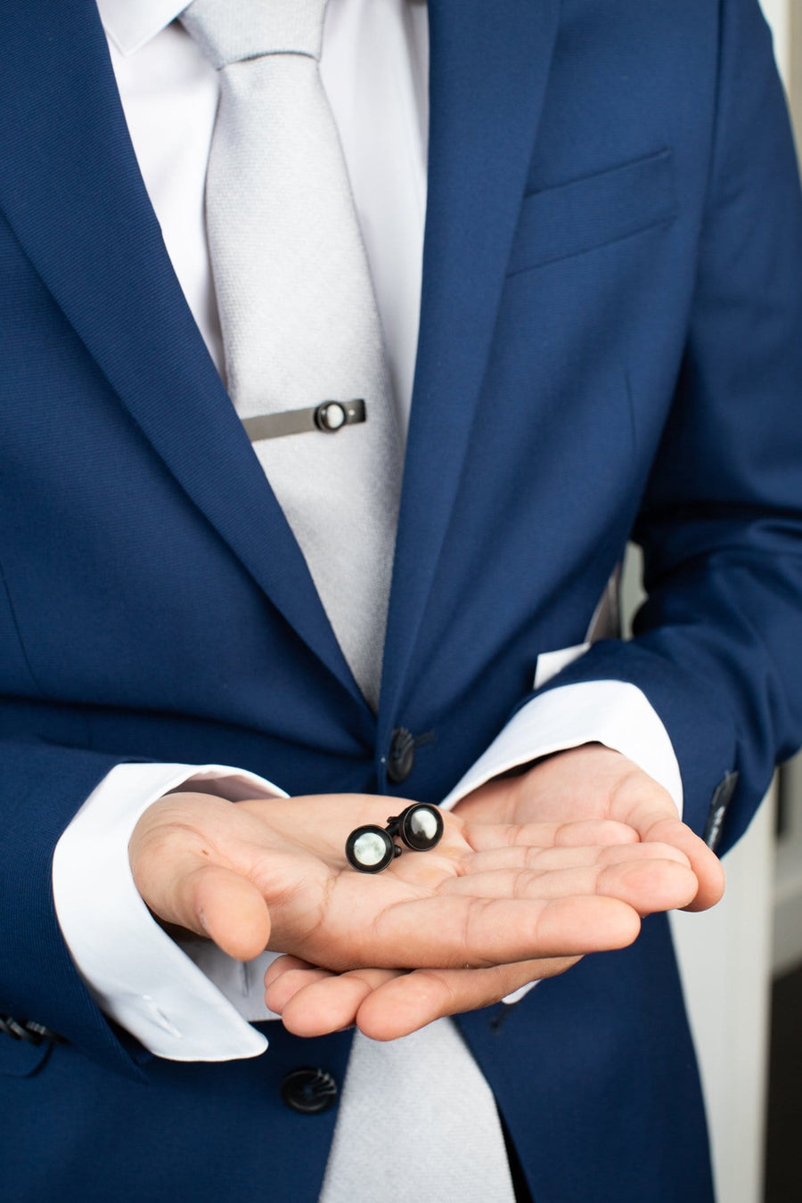 Man holding The Maginus Cufflinks in Black Matte