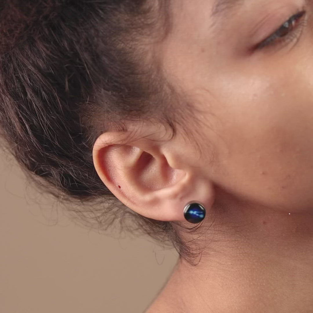 Video of woman wearing silver plated constellation astrology stud earring