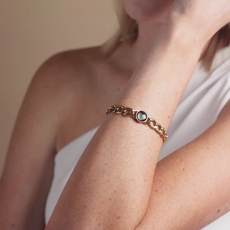Video of woman wearing gold plated moon phase link bracelet