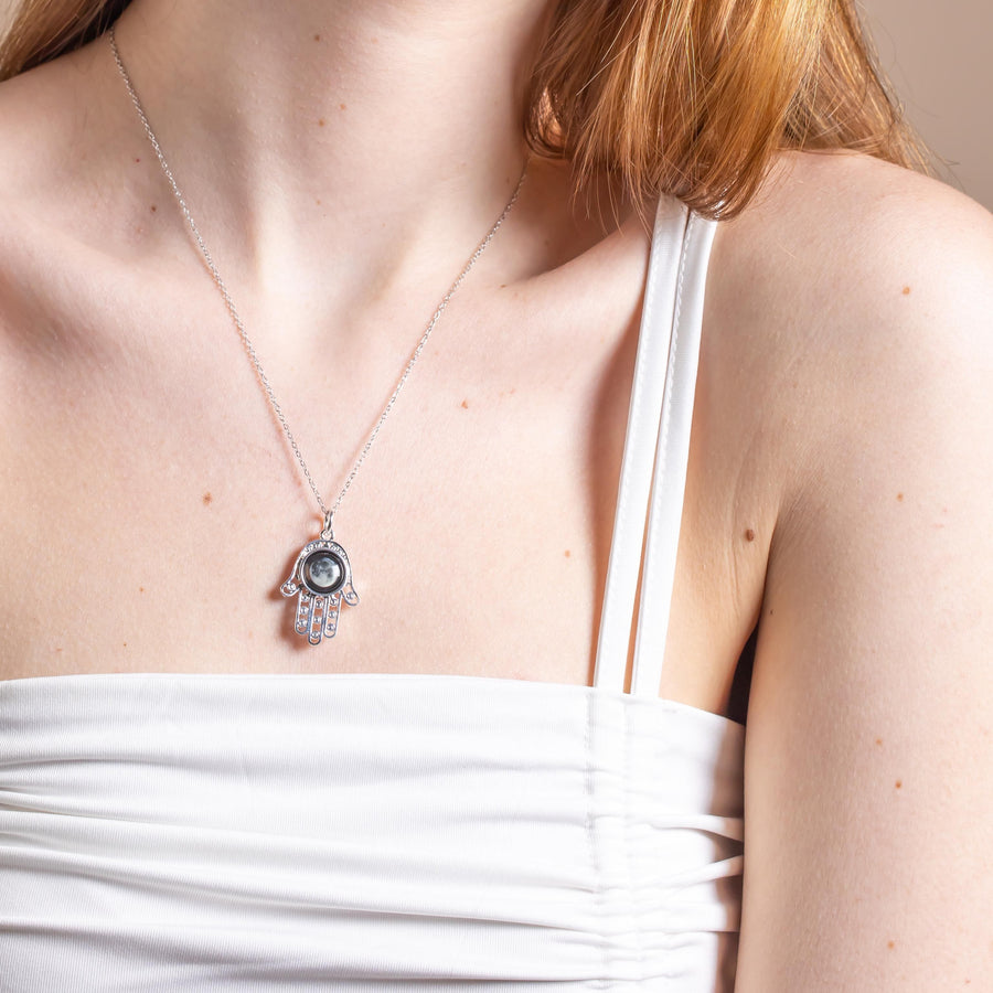 Woman wearing Moon phase Healing Hand Pendant