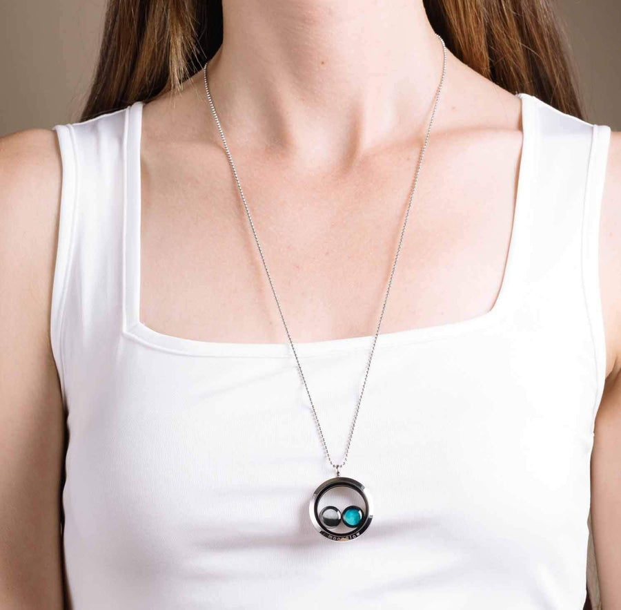 Woman wearing two moon phase locket necklace in stainless steel