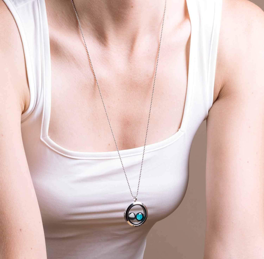 woman wearing two moon phase locket necklace in stainless steel
