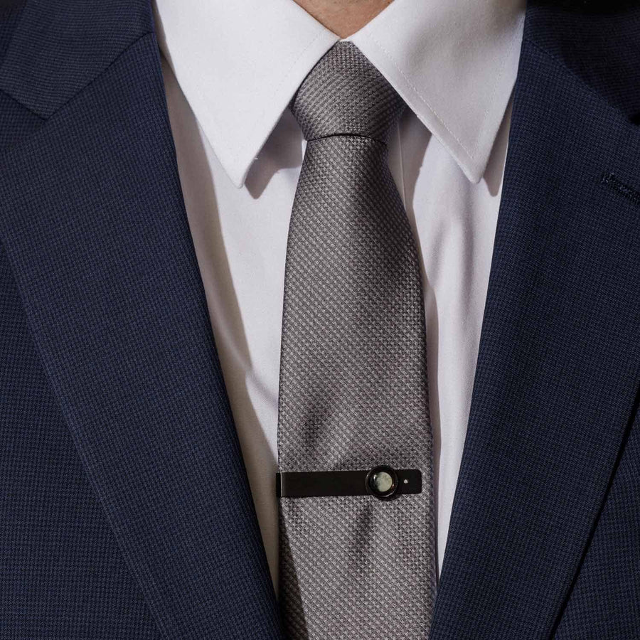 Man wearing moon phase tie bar in matte black stainless steel